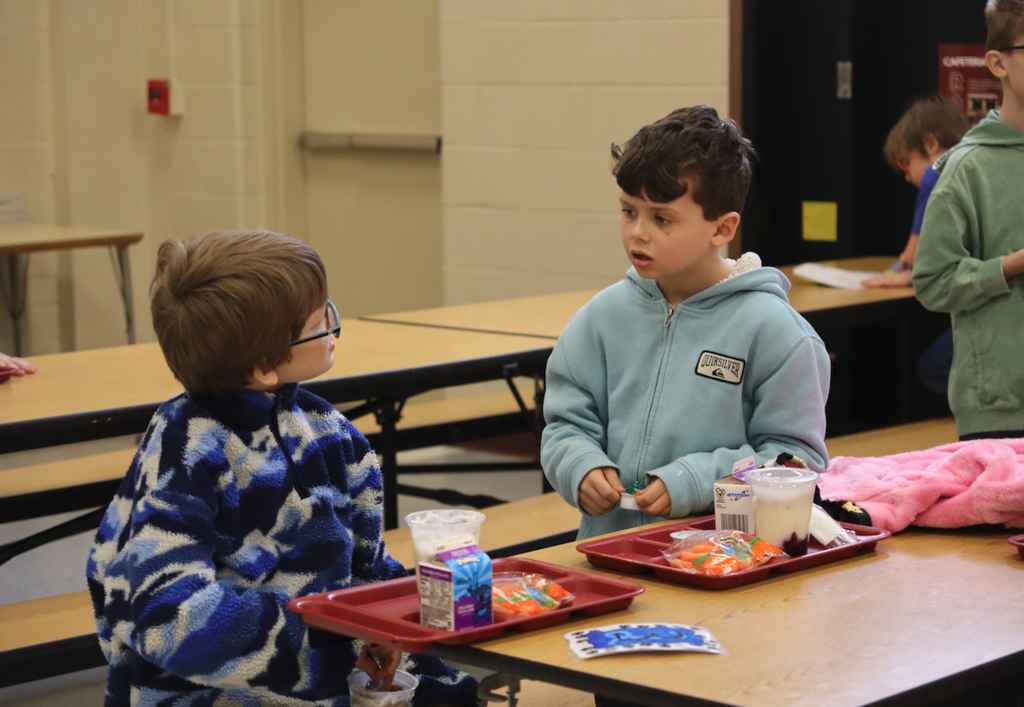 little boys talking together at lunch