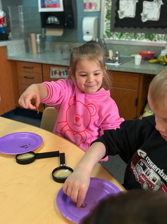 little girl holding worm