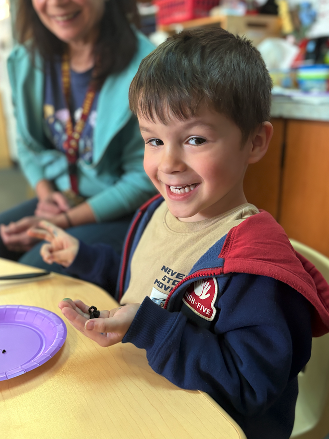 little boy holding worm