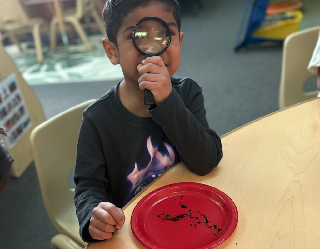 little boy with magnifying glass