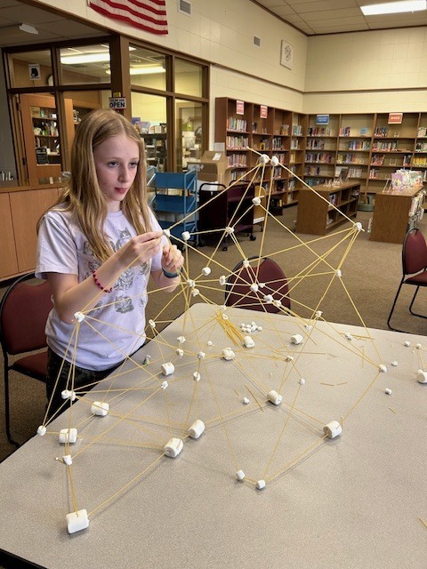 girl building marshmallow tower