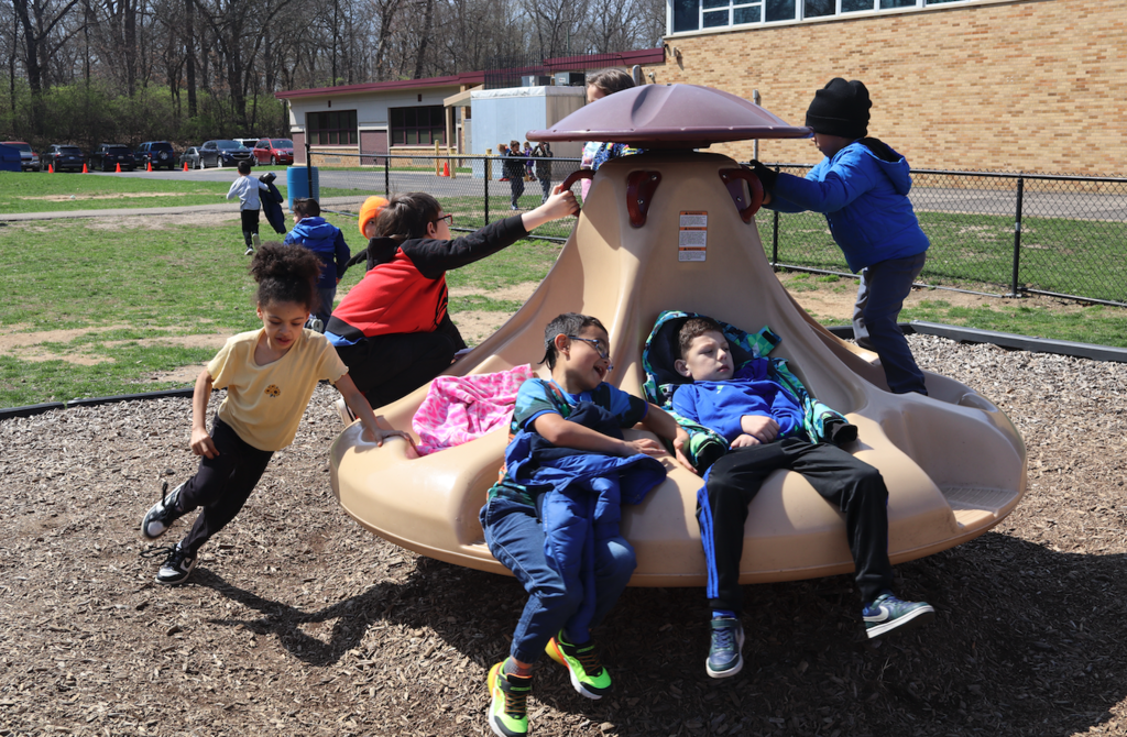 group of children on merry go round 