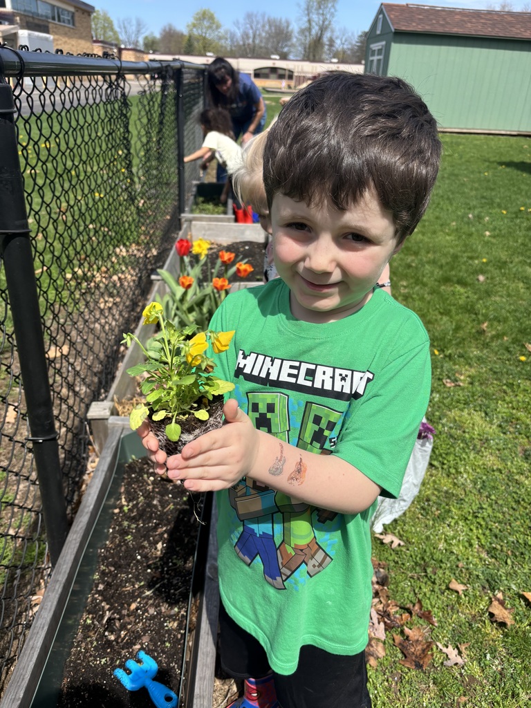 little boy holding flowers