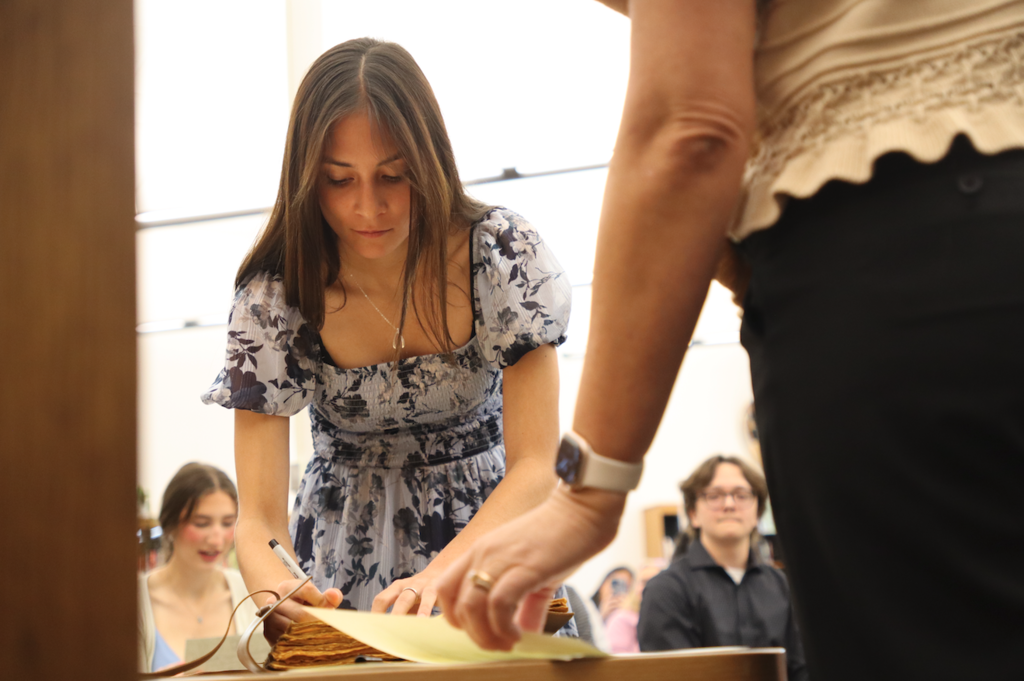 young woman signing book