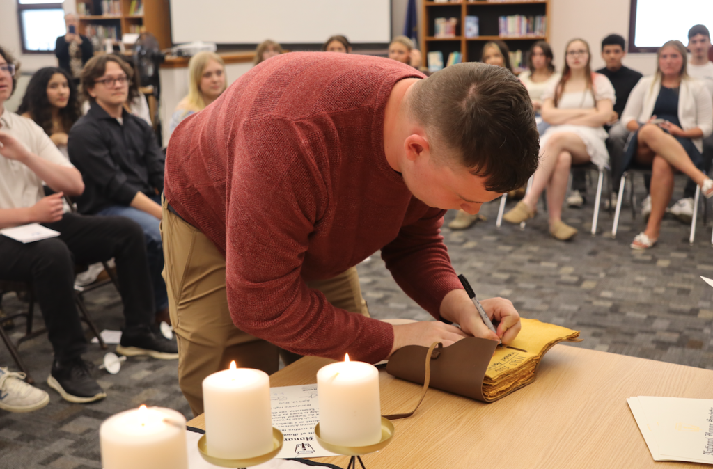 young man signing book