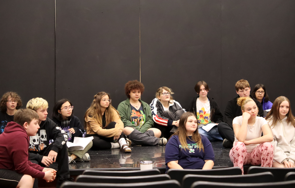 group of students sitting on stage