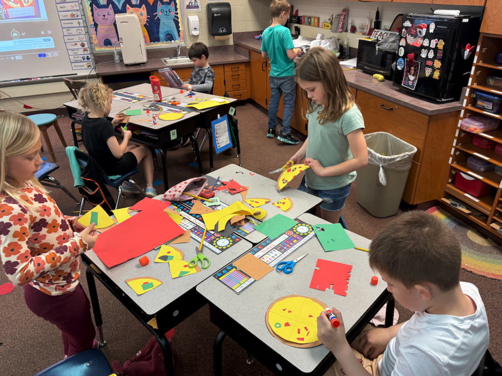 kids working at desk creating pizzas