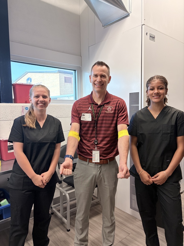principal Evan Winkler with two students who drew his blood