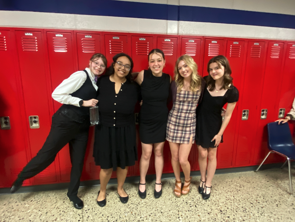 five choir girls standing in front of lockers