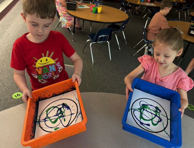 two little students working on paint project