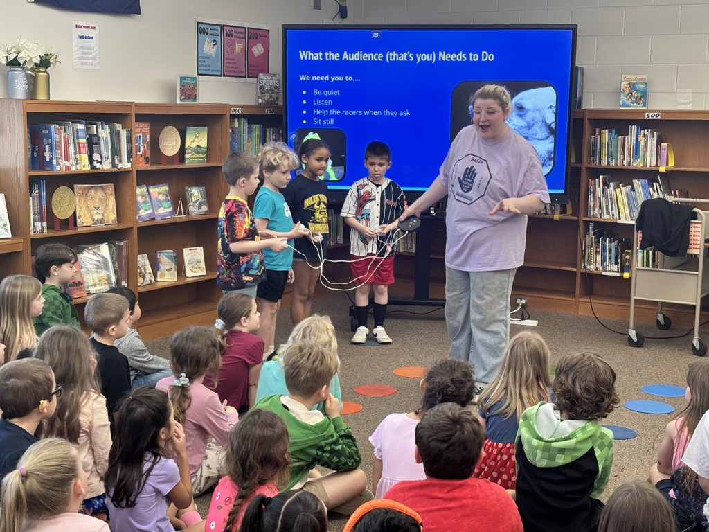 students speaking to elementary students