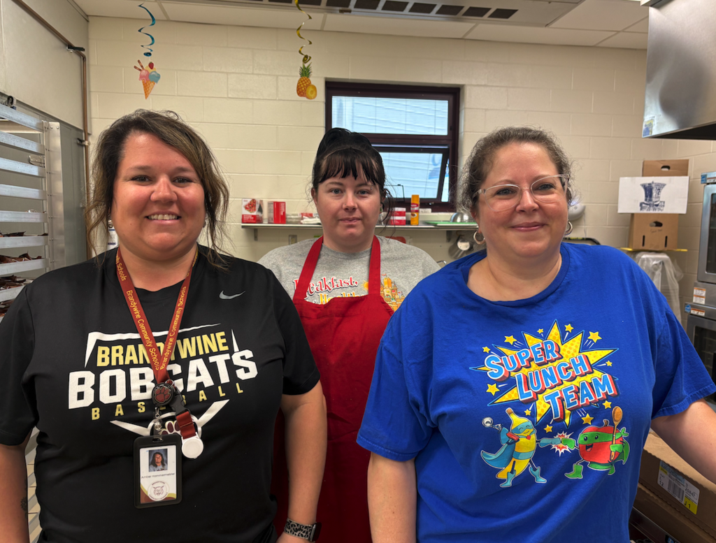three lunch ladies standing in kitchen