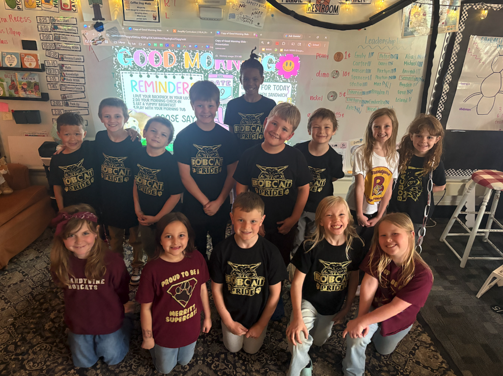 group of kids with t shirts on in front of a project screen