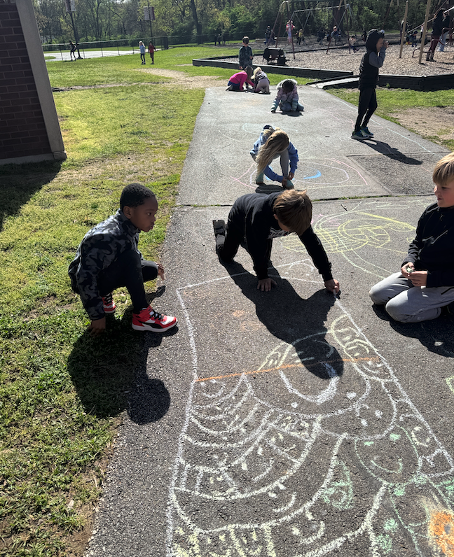 children drawing on sidewalk with chalk