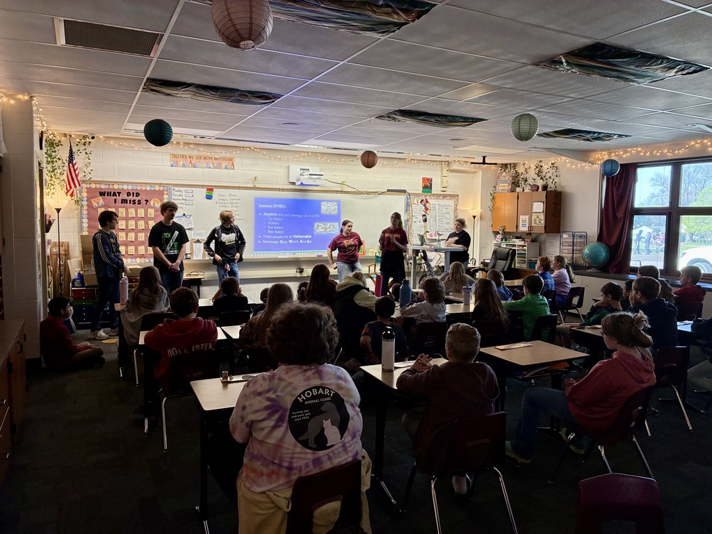 group of students presenting to elementary students