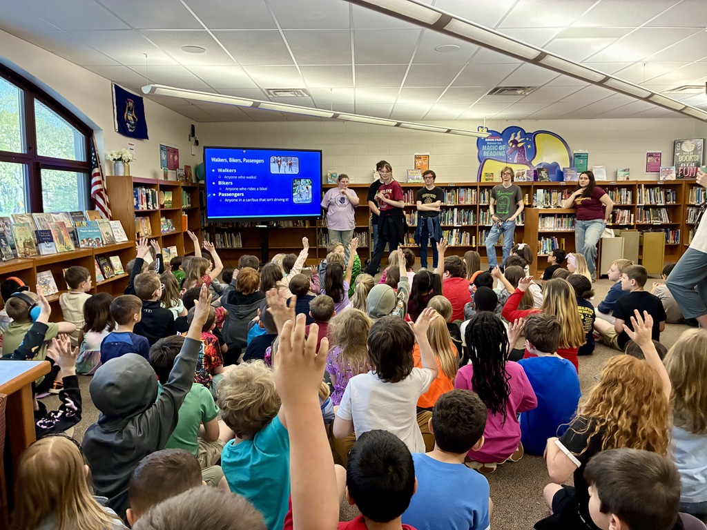 group of students presenting to elementary students