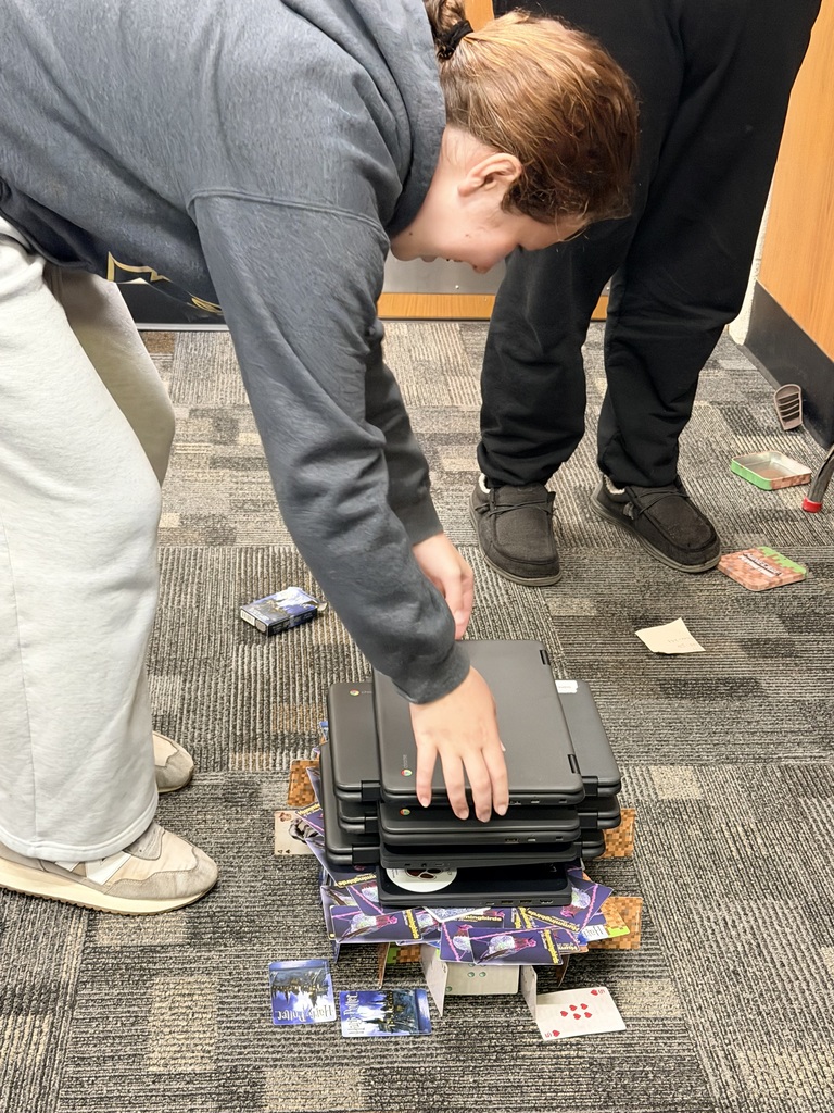students putting Chromebooks on tower