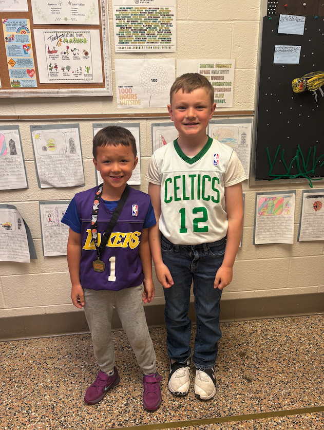 two boys dressed in basketball jerseys