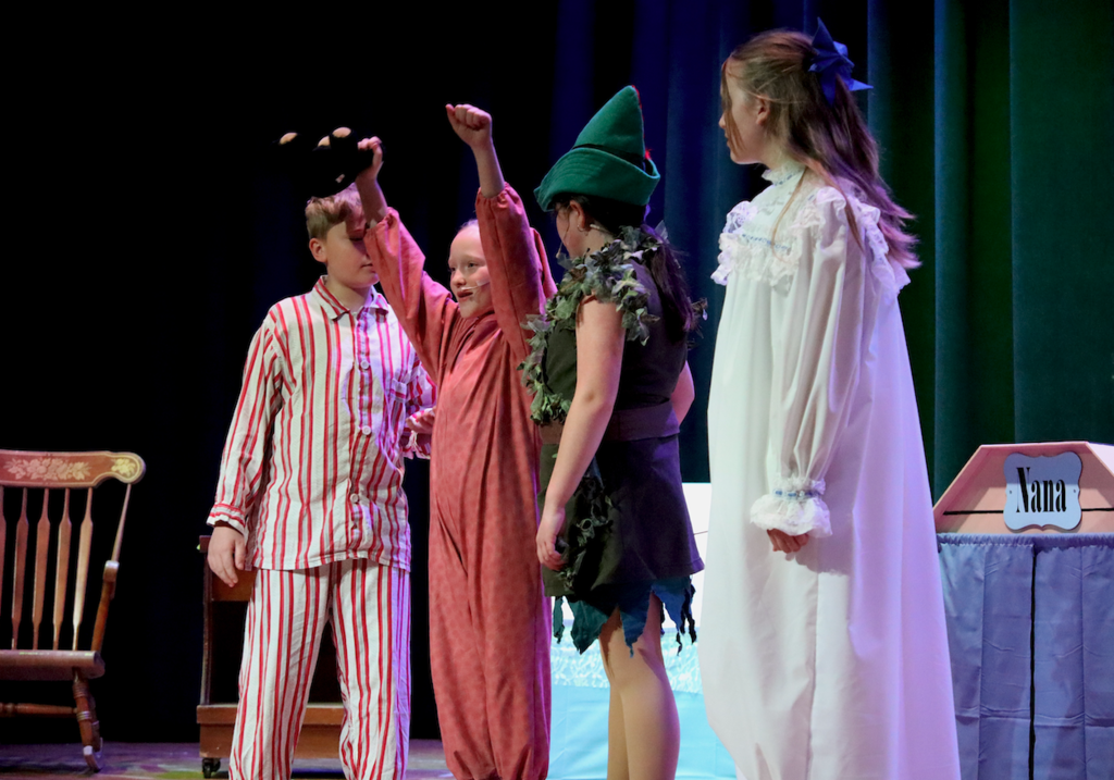 Peter Pan with siblings, little girl with arms up