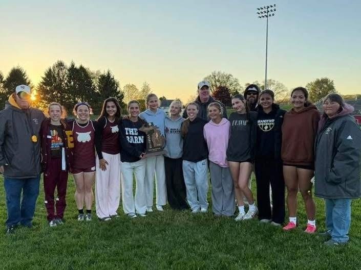 Group of girls on track team with coaches