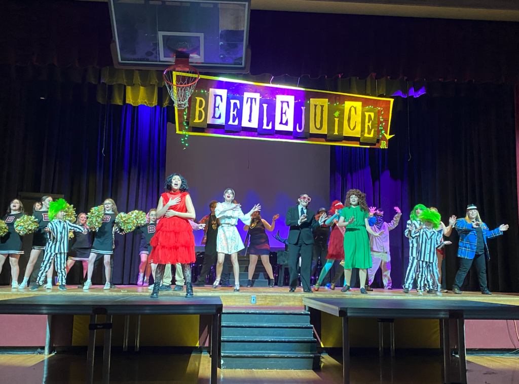 Beetlejuice cast on stage singing
