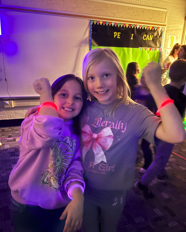 two girls showing off their glow bracelets