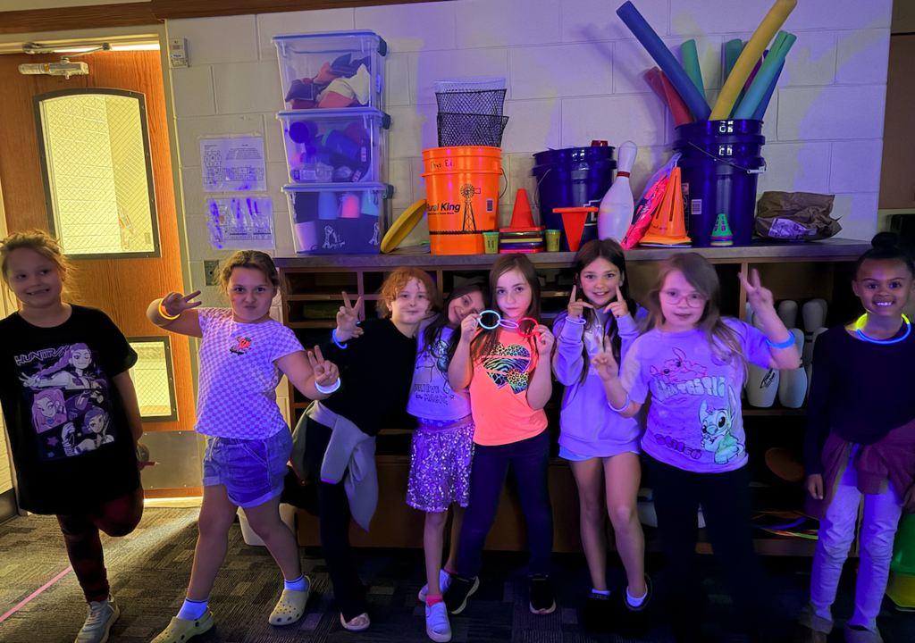 group of girls wearing glow sticks
