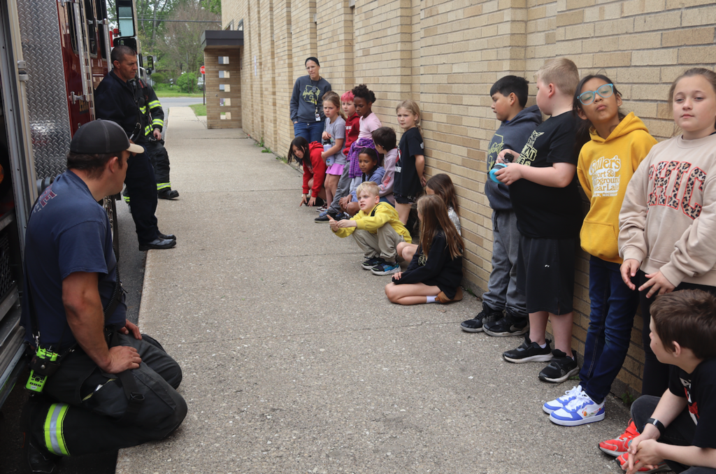 students listening to fireman