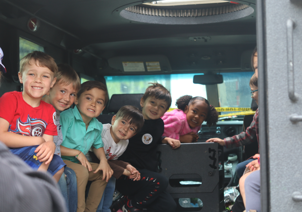 students sitting in in sheriffs truck