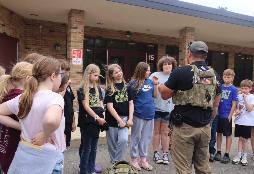 students listening to sheriff 