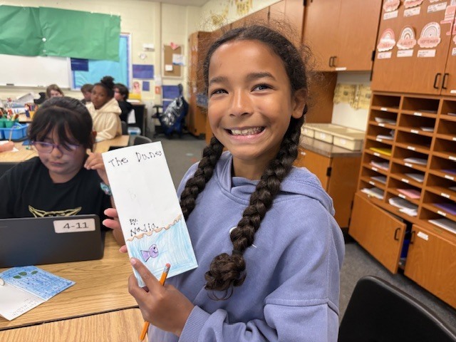 young girl showing brochure