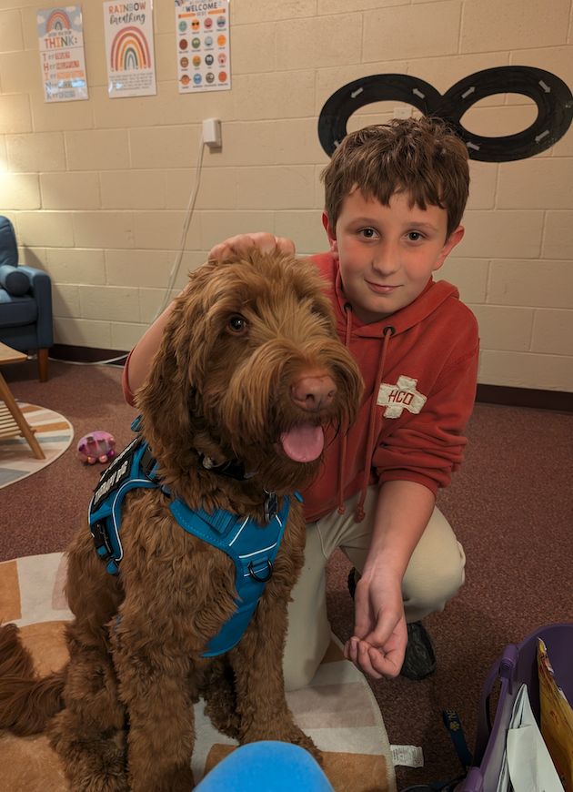 little boy with copper the therapy dog