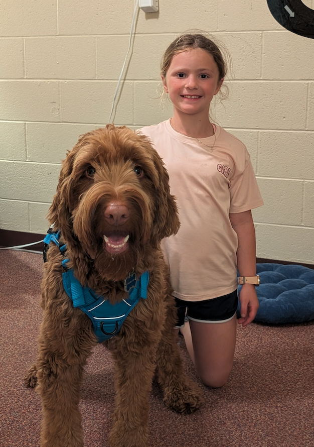 little girl with copper the therapy dog
