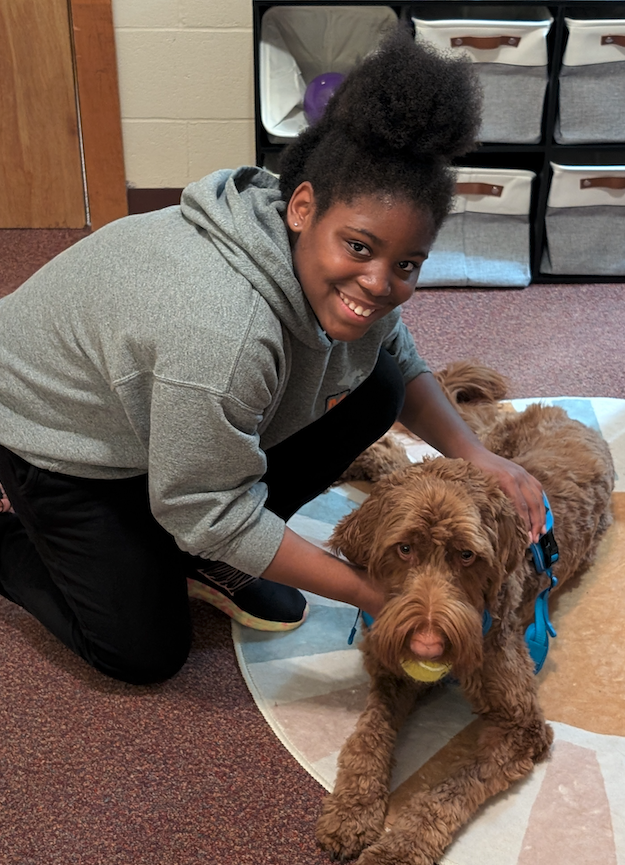 little girl with copper the therapy dog