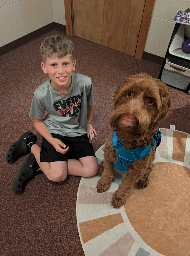 little boy  with copper the therapy dog