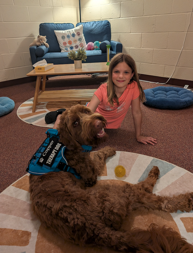 little girl with copper the therapy dog