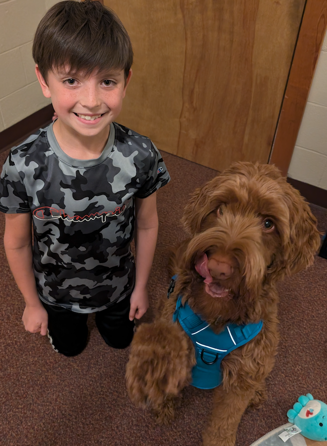 little boy with copper the therapy dog