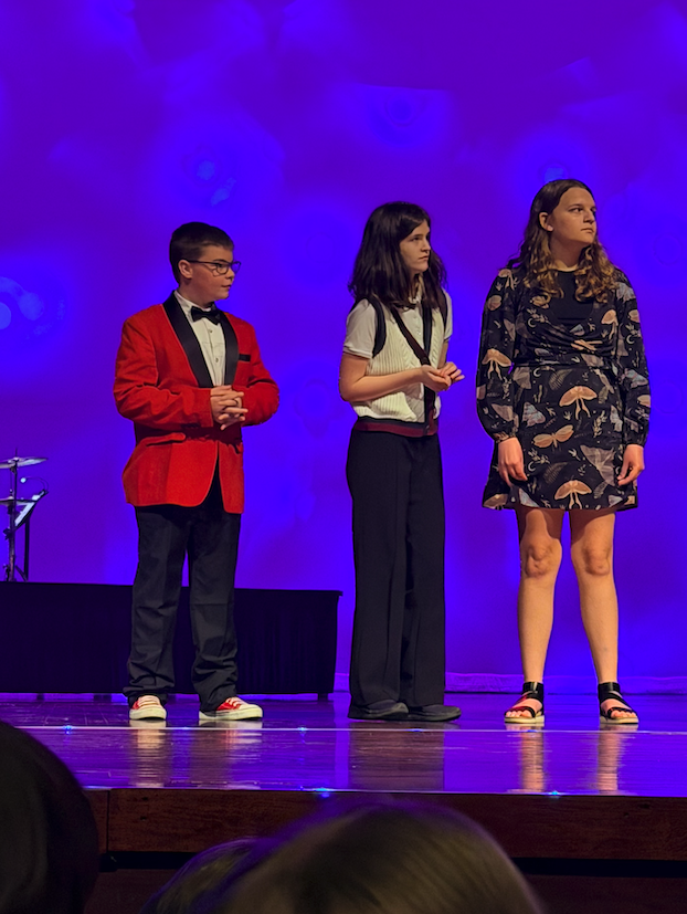 three students on stage 