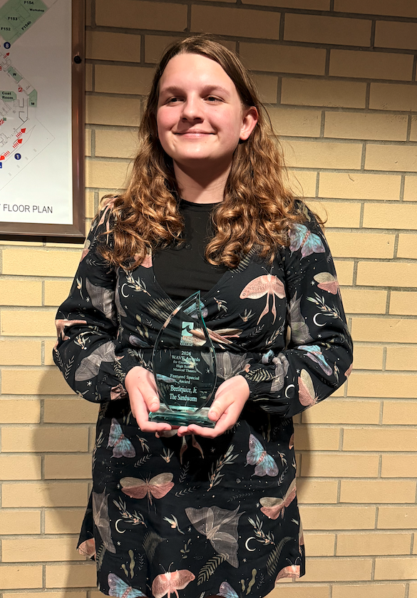student with glass award