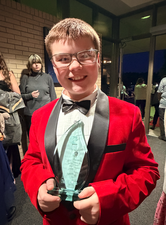 student with glass award