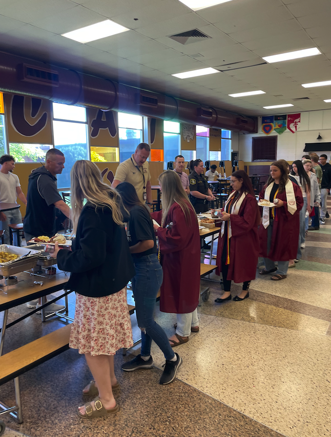 students in line grabbing breakfast in cafeteria