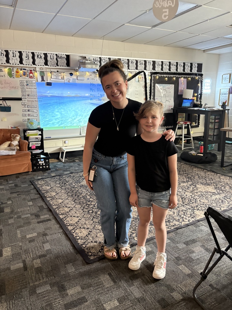 teacher standing with student dressed in same outfit