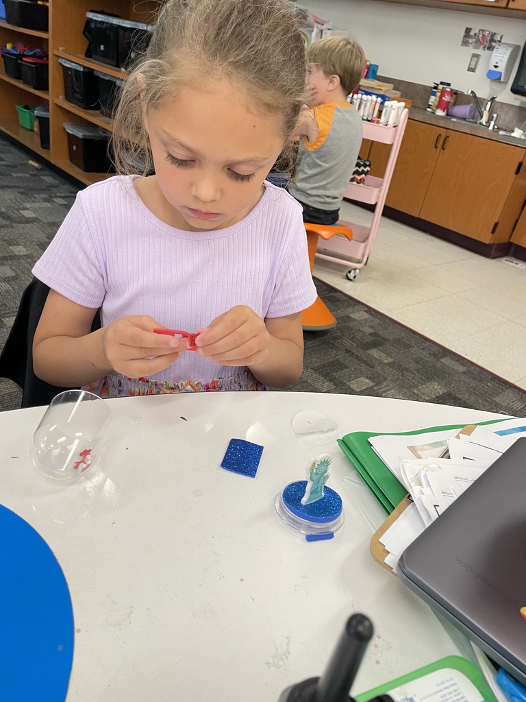 kindergartener making a craft