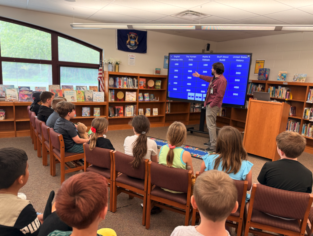 students playing jeopardy in the library