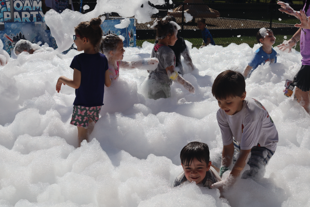 group of kids playing in foam