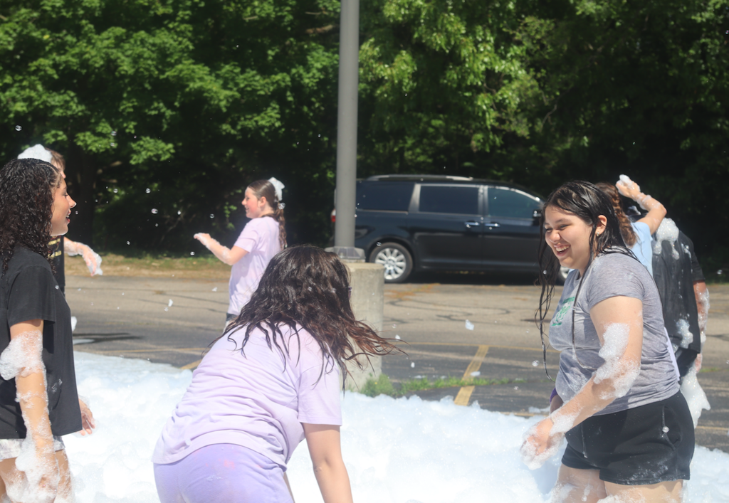 group of girls playing in foam