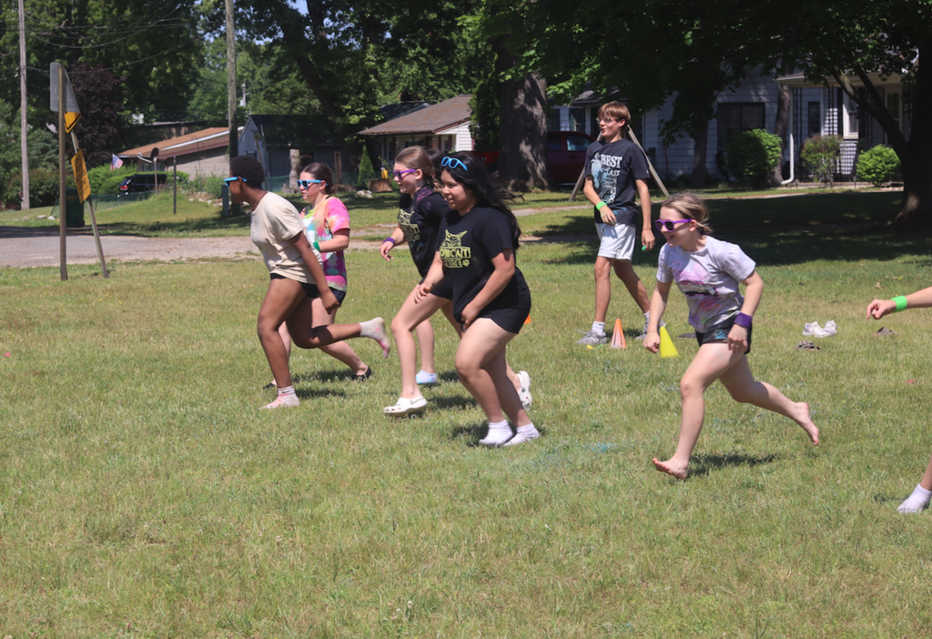 group of kids running outside 