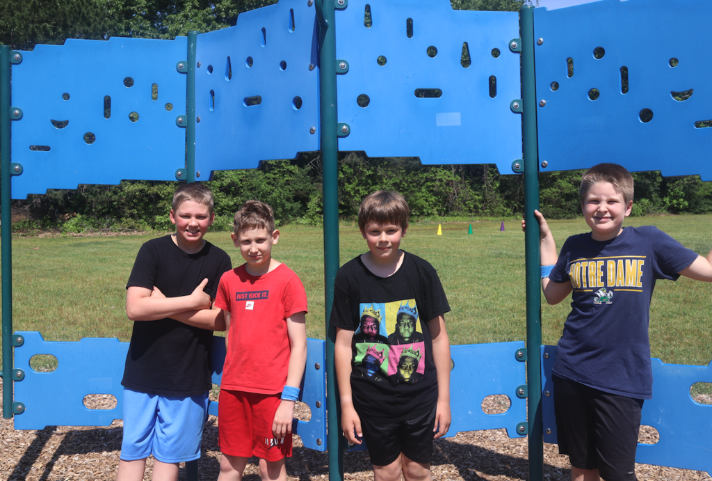 four boys standing on the playground