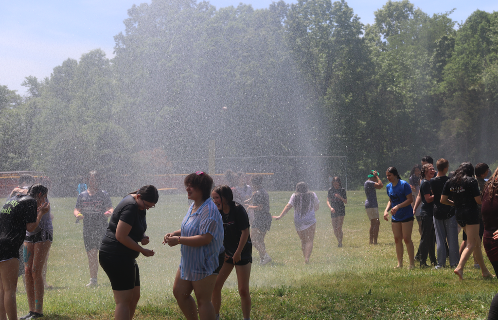 kids standing under fire truck hose 