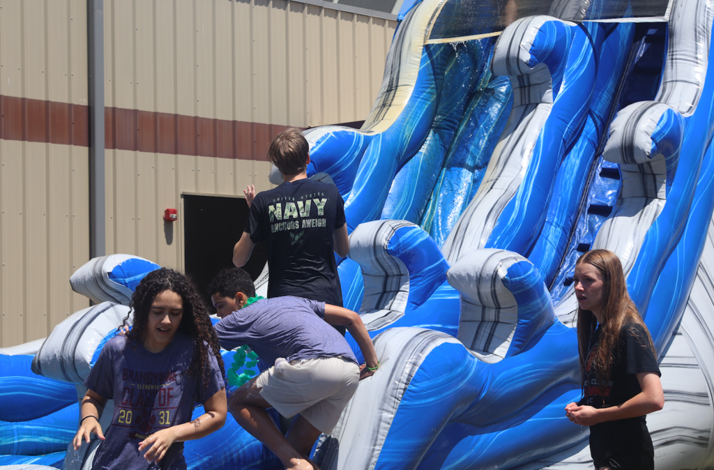 kids on inflatable water slide